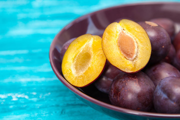 Fresh tasty plums in a bowl