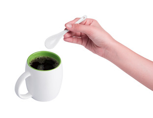 Hand holding white spoon and red cup of coffee isolated on white