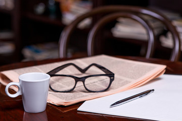 Cup of Coffee and Newspaper