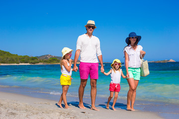 Happy family of four on beach vacation