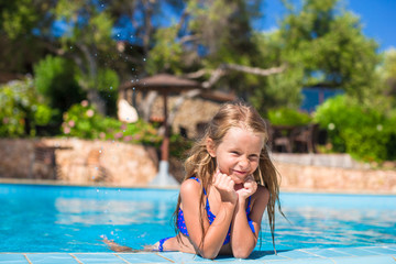 Adorable happy little girl have fun in the swimming pool
