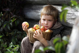 boy with a basket of apples in the hands of