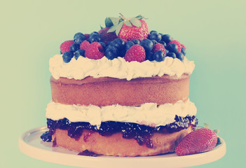 Retro style layer sponge cake with fresh cream and berries