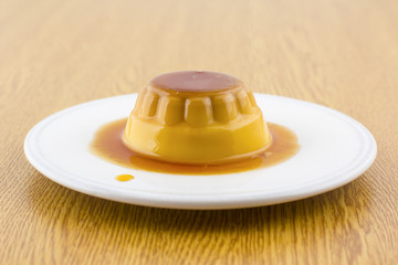 Fototapeta premium Creme caramel vanilla custard dessert or flan on white dish