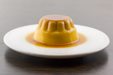 Creme caramel vanilla custard dessert or flan on white dish