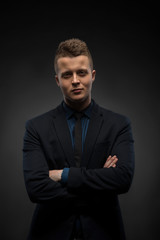 Waist-up portrait of handsome businessman with strong and confid