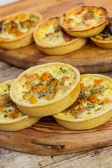 Quiche lorraine on wooden board