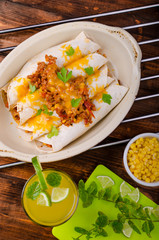 Baked meat tortilla with cheddar cheese