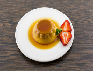 Creme caramel vanilla custard dessert or flan on white dish