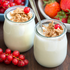Jars of fresh natural yogurt and  blueberries