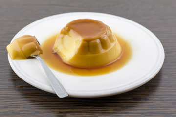 Creme caramel vanilla custard dessert or flan on white dish