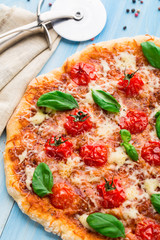 Pizza with cherry tomatoes and basil