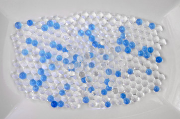 White and blue shiny balls on a plate