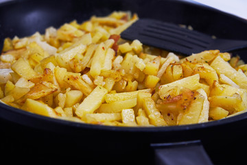 Juicy fried potatoes in a pan