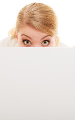 Businesswoman hiding behind blank copy space banner