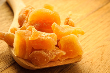 Closeup candied ginger on wooden spoon