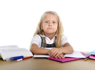 sweet little school girl tired and sad in stress at homework