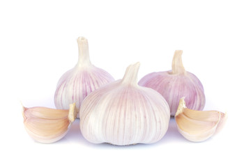 Garlic bulb and cloves on white background