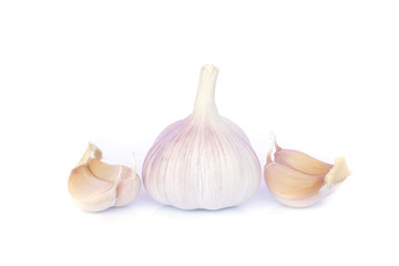 Garlic bulb and cloves on white background
