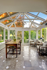 Sunroom patio area with transparent vaulted ceiling