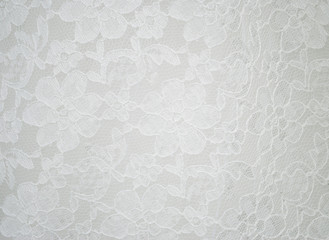 white fabric with a pattern of flowers background