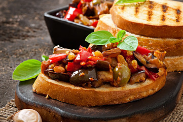 Bruschetta caponata with raisins and pine nuts decorated with a 
