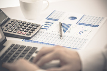 man hand with pen and business report. Accounting