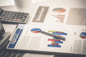Fototapeta premium Businessman analyzing investment charts with laptop. Accounting