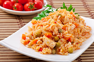 Pilaf with chicken, carrot and green peas
