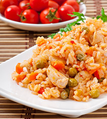 Pilaf with chicken, carrot and green peas