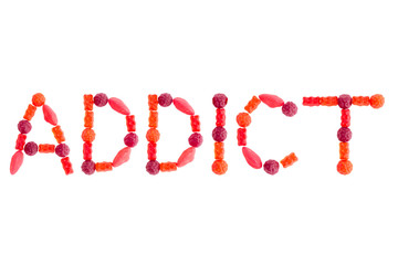 Word "ADDICT" made of red sugary candies, isolated