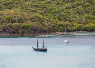 Fototapeta na wymiar Old Blue Sailboat in Bay