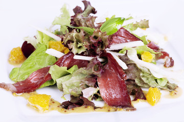 jerked beef, salad, lettuce, orange on the plate