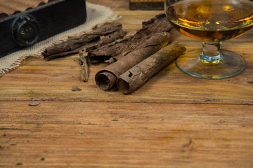 Fototapeta na wymiar Cigars and Rum or alcohol on table