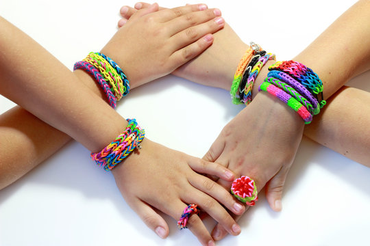 Elastic and colorful rainbow loom bracelet on hands