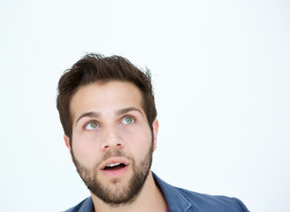 Young man looking up with surprised expression