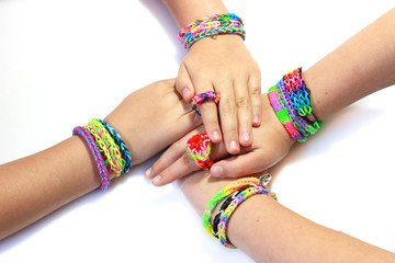 Elastic and colorful rainbow loom bracelet on hands - 70613628
