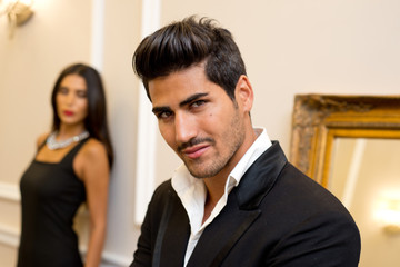 Fashionable male and female model in an elegant setting
