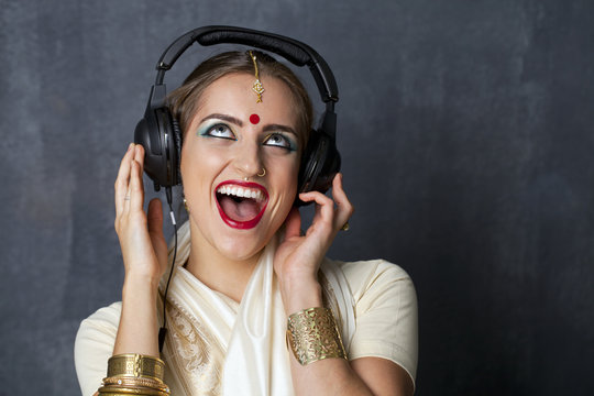 Beautiful Indian Woman Listening To Music On Headphones