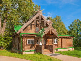 Old wooden house decorated with carvings in  forest