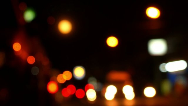 Blurred Defocused Lights of Traffic on Road at Night. Speed up.