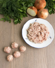 raw meatballs and minced meat in a plate, with ingredients, top