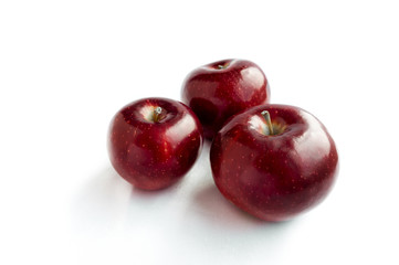 Three fresh red apples isolated on white background