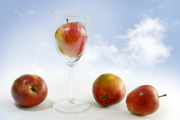 red apples, one of them is in a glass, symbol of apple juice, ba