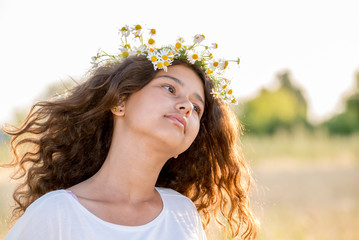 Teen girl with  wreath of daisies