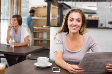 Pretty blonde reading the newspaper