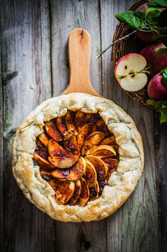 Apple pie on rustic wooden background