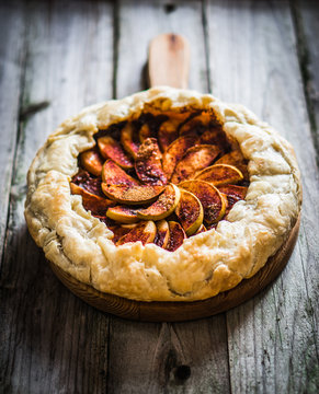 Apple pie on rustic wooden background