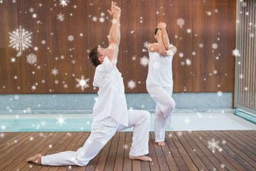 Peaceful couple in white doing yoga together