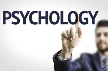 Business man pointing to transparent board with text: Psychology